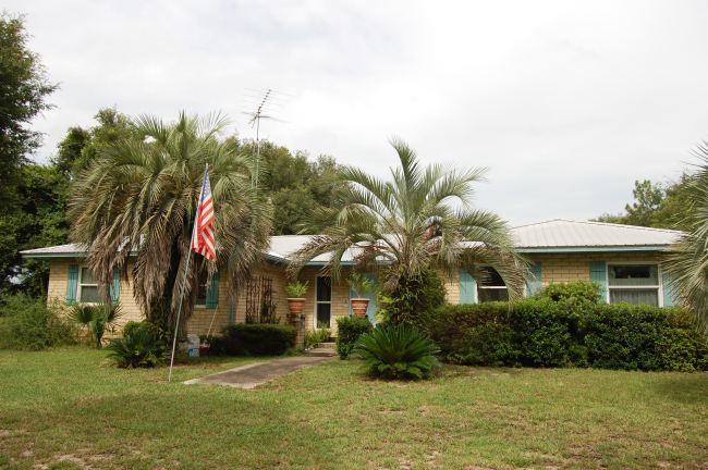 Great family home in wonderful location. 4 bedroom, 2 bath brick pool home with breakfast area & separate dining room. Fourth bedroom 18x11, it could be used for an in-home office or would make a great game room. (Located at other end of home from bedrooms) Large living room overlooking pool area. Home features court yard entrance, pond with Koi & turtles, back porch and fenced back yard around pool. All of the bedrooms have ceiling fans and large closets. Up dated windows in home are just two years old, double pane, tilt out for easy cleaning. Heat pump/air handler is just 2 years old. Home also has a lifetime metal roof. Kitchen features up dated Corian counter tops, deep-double sinks as well as large deep-double sink in 12x11 over sized laundry room. Master bathroom tub/shower has been updated with large shower. Workshop/shed tucked away in yard. HOME WARRANTY & $1,200 FLOORING ALLOWANCE. 