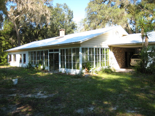 So much potiential. This property is a nature lovers dream, Situated beneath a canopy of majestic oaks, features include over two dozen Camelias, azelas, & palm trees, fruit trees, landscape rocks ready to design a garden as well as an outdoor waterfall & an indoor waterfall. There is also a four �acre lake with wild life habitat areas and nature trails. The 2,300 square foot home sits on twenty-four acres with over 1,500 feet of highway frontage. The home features many artistic touches along with a new metal roof, stone fireplace, glass solarium, out buildings and a four stall horse shed. Don't miss this once in a lifetime opportunity to own a piece of real Florida at an unbelievable price. Just 20 minutes from Gainesville. 