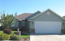 One owner, better than when built in 2003. 1520 sq ft of 1 floor living in gated but not 55+ PUD. 2 bedrooms, 2 baths, den-office, gas furnace + fireplace, all appliances + w/d stay, patio w/pergola, vinyl fencing. Home recently painted. 22'x23' 2 car gar. $210 mo. HOA fee for water, sewer, common grounds, snow removal & weekly mowing. CC&R's, handicap access, east & west security gates.