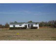 If you love the country- bring your horses to this 10 acres of fenced pasture with a 3 bedroom/ 3 full bath home. Home is set back from the roadway. Acreage is cleared, fenced and cross fenced with high quality hot wire. There is lots of room for live stock and the soil is great for a garden. Property is high and dry. Master bedroom has 2 master bathrooms for him and her and a large walk thru closet. There are many upgrades in this home which include sheetrock walls, double-paned windows, french doors and a fireplace. Purchase this property and you can enjoy the pleasures of country living.Call today for an appointment.